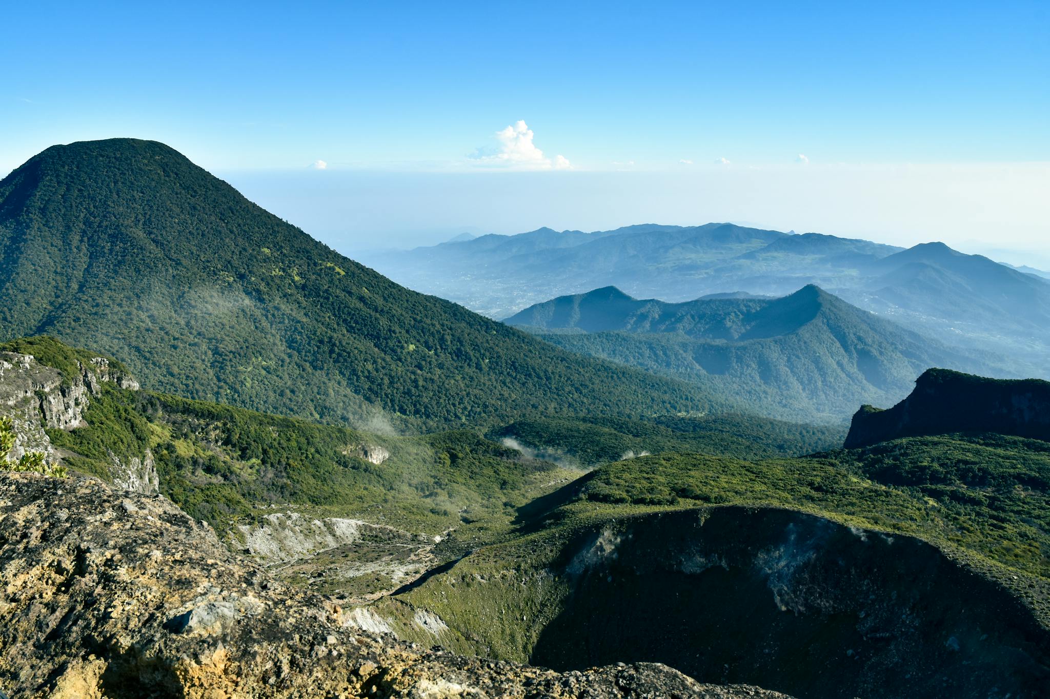 Explore the breathtaking view of a serene mountain landscape with clear blue skies.