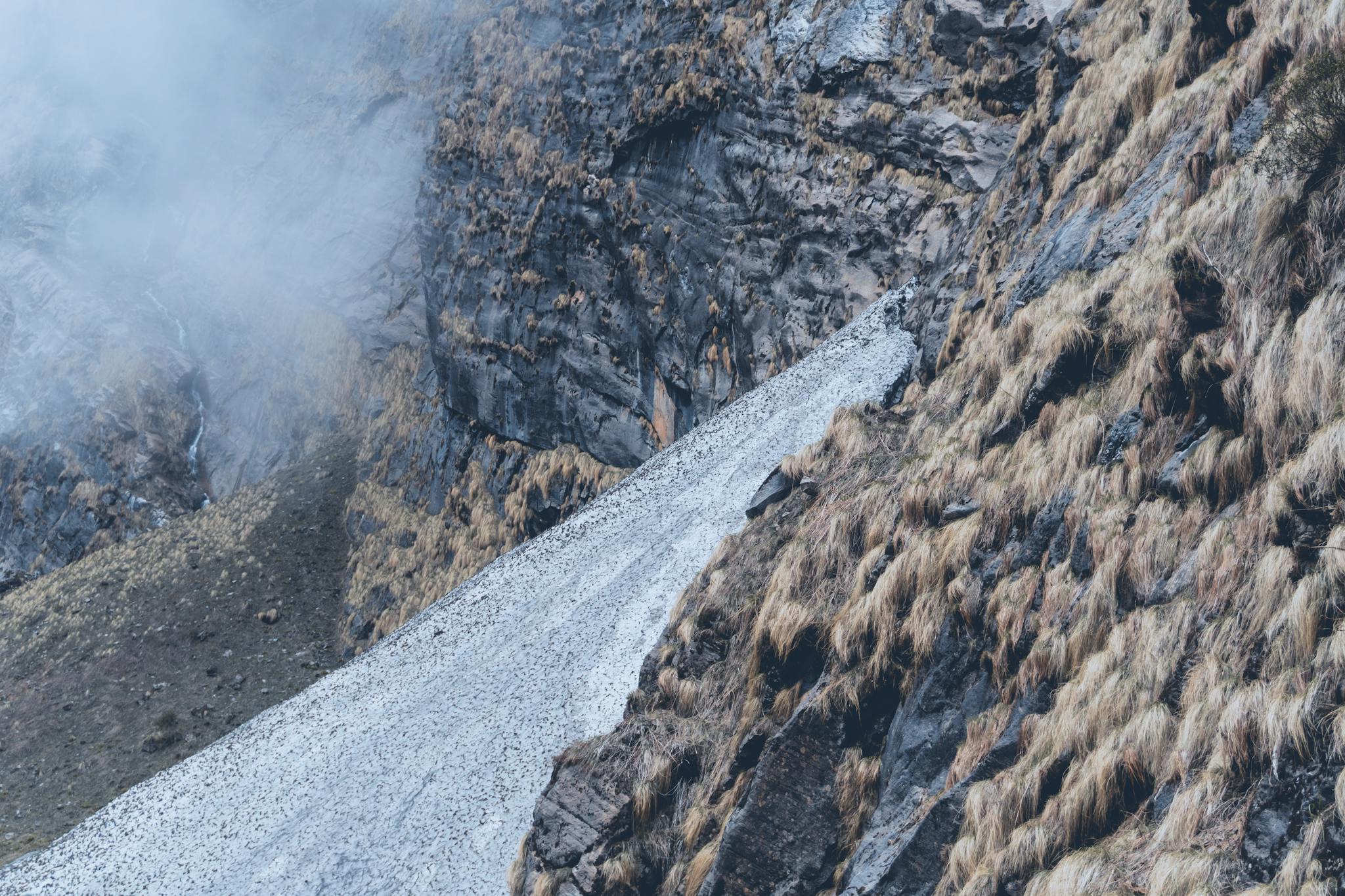 Explore the misty mountain slopes of Annapurna, Nepal, capturing rugged beauty and pristine nature.